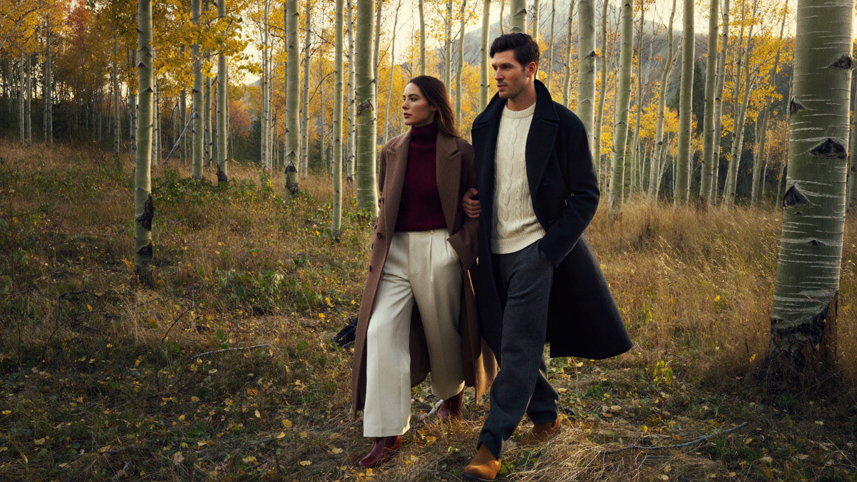 Couple walking through golden aspens in Colorado